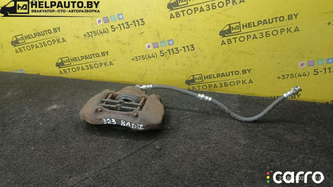 суппорт тормозной передний левый Mazda 323 6 поколение 1998г. - фото №1